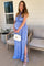 pregnant woman in blue floral halter maxi dress holding white quilted handbag on a patio