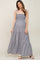woman wearing a navy blue and white gingham smocked maternity maxi dress with tie straps
