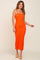 woman wearing a fitted orange ribbed midi dress with spaghetti straps and tan slide sandals