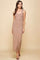 woman wearing a form-fitting beige maxi dress with thin straps and a straight silhouette
