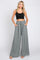 woman wearing black crop top and grey wide leg palazzo pants with drawstring waist
