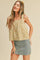 woman wearing a yellow floral crop top with tie straps and a denim mini skirt