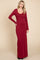 woman wearing a burgundy long sleeve maxi dress with a scoop neckline, standing against a neutral background