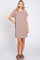 woman wearing a brown striped short sleeve dress with a chest pocket and standing in a relaxed pose