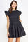 woman wearing a black short smocked dress with ruffle sleeves and a flared skirt