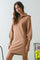 woman wearing a tan long sleeve zip-up sweater dress with puffed sleeves and a relaxed fit