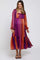woman wearing a colorful striped maternity dress with long sleeves and a tiered hem, accentuating her baby bump