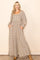 woman wearing a floral print long sleeve maxi dress with pockets and a square neckline