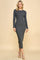 woman wearing a fitted long sleeve gray ribbed midi dress with a round neckline and side slit