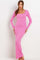 woman wearing a pink long sleeve ribbed maxi dress with a square neckline and form-fitting silhouette