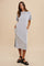 woman wearing a light gray ribbed midi dress with short sleeves and side pockets