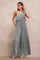 woman wearing a silver one-shoulder pleated jumpsuit with wide legs and side pockets