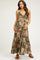 woman wearing a floral print maternity maxi dress with a halter neckline and adjustable straps, showing her baby bump