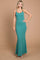woman wearing a teal ribbed maxi dress with a fitted silhouette and flared bottom, standing against a neutral background