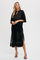 woman wearing a black crochet midi dress with a tie neckline and short sleeves, standing against a plain background