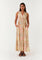 woman wearing a sleeveless floral maxi dress with a button-down front and pockets, standing against a plain background