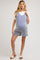 woman wearing a striped blue and white maternity romper with a loose fit and pockets