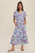 woman wearing a light blue floral maxi dress with short flutter sleeves and pockets
