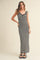woman wearing a black and white checkered maxi dress with ruffle straps and a fitted silhouette