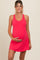woman wearing a bright pink maternity dress and holding her baby bump