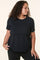 woman wearing a black short sleeve layered top with a relaxed fit and round neckline
