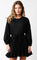 woman wearing a black long sleeve dress with a tie waist and ruffled hem