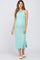 pregnant woman wearing a mint green ribbed maternity midi dress and white slide sandals