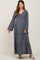 Pregnant woman wearing a charcoal grey long sleeve tiered maternity maxi dress with smocked bodice