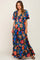 woman wearing a black floral print maxi dress with short flutter sleeves and a v-neckline