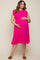 pregnant woman in a hot pink smocked maternity dress with ruffle sleeves and a tiered hem