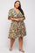 plus size woman wearing a short sleeve floral wrap dress with a v-neckline and tan block heel sandals