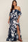 woman in navy blue and white floral off-the-shoulder maternity maxi dress with a leg slit