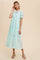 woman wearing a light blue lace tiered midi dress with puff sleeves and tan block heel sandals