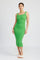 woman wearing a bright green ribbed midi dress with a scoop neckline and form-fitting silhouette