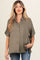 woman wearing an olive green short sleeve button-up maternity shirt, styled with loose fit and side pockets