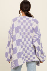woman wearing a purple and white checkered oversized knit sweater from the back