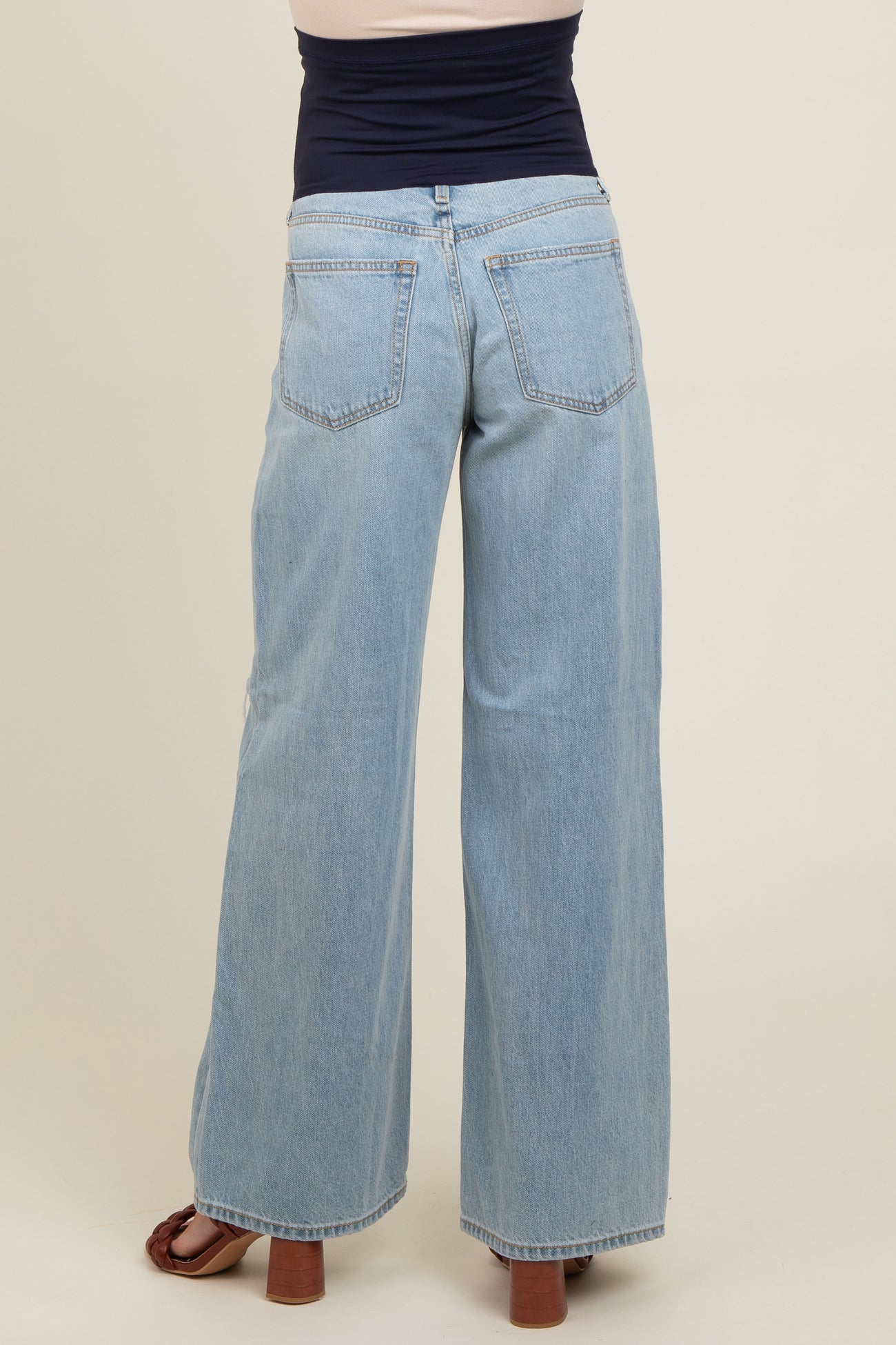maternity wear light blue wide leg jeans with a stretchy waistband, model shown from the back