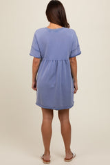 woman wearing a light blue short sleeve maternity dress with a relaxed fit and frayed hem