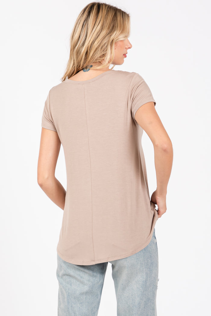woman wearing a taupe short sleeve top with a rounded hem and back seam detail