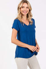 woman wearing a navy blue v-neck t-shirt with rolled sleeves and a relaxed fit