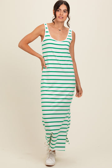 woman wearing a green and white striped maxi dress with a scoop neckline and side slits, paired with white sneakers
