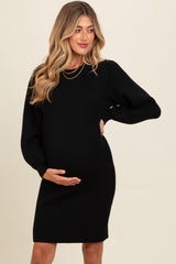 woman wearing a black ribbed maternity dress highlighting her baby bump