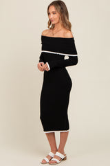 woman wearing a black ribbed off-the-shoulder midi dress with white trim and white heeled sandals