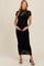 woman wearing a black floral lace maternity dress with a fitted silhouette and short sleeves, holding her baby bump