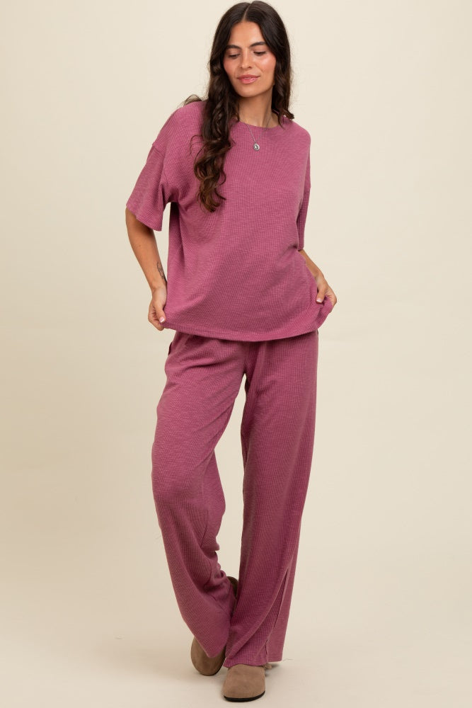woman wearing a mauve relaxed fit short sleeve top and matching wide leg pants in a textured fabric