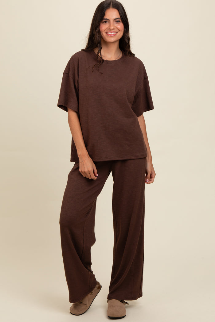woman wearing a brown oversized knit lounge set with wide-leg pants and a relaxed fit top
