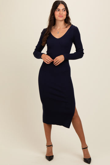 woman wearing a navy ribbed long sleeve midi dress with a v-neck and side slit