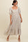 woman wearing a cream floral maxi dress with puff sleeves and a square neckline