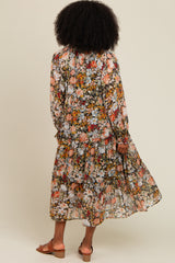 woman wearing a floral long sleeve maxi dress with a tiered skirt, standing with her back to the camera