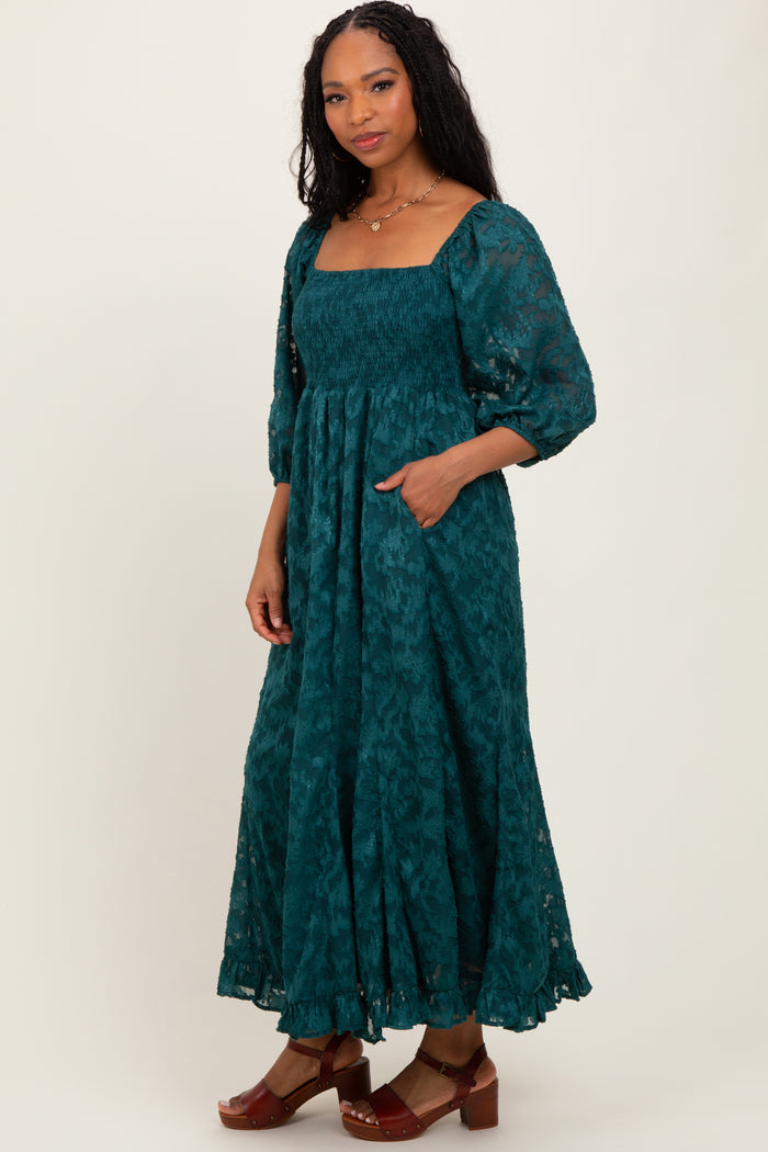 woman wearing a teal long sleeve maxi dress with square neckline and pockets